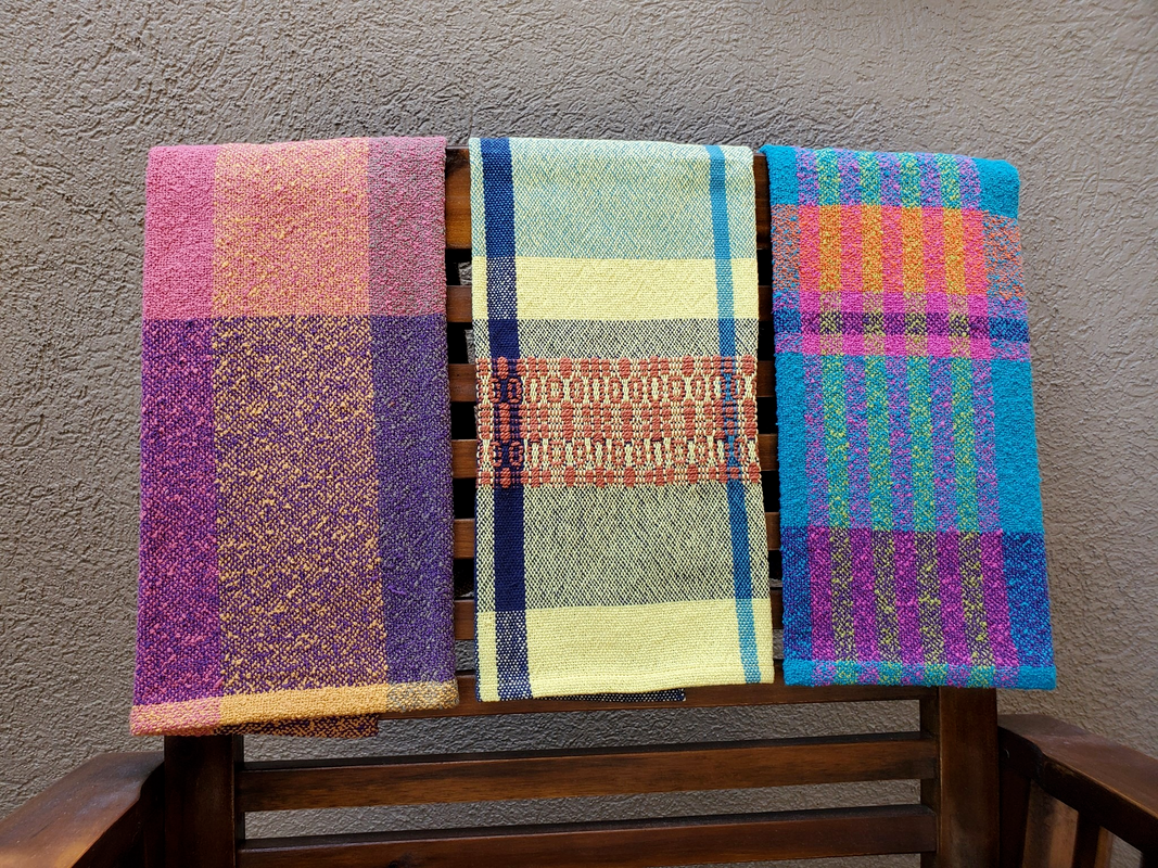 Three multicolored handwoven towels