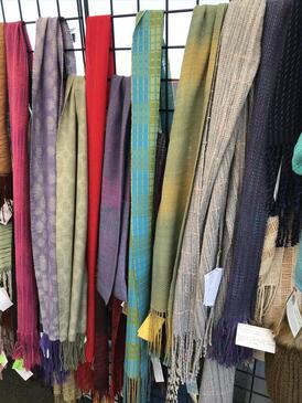 A dozen handwoven scarves