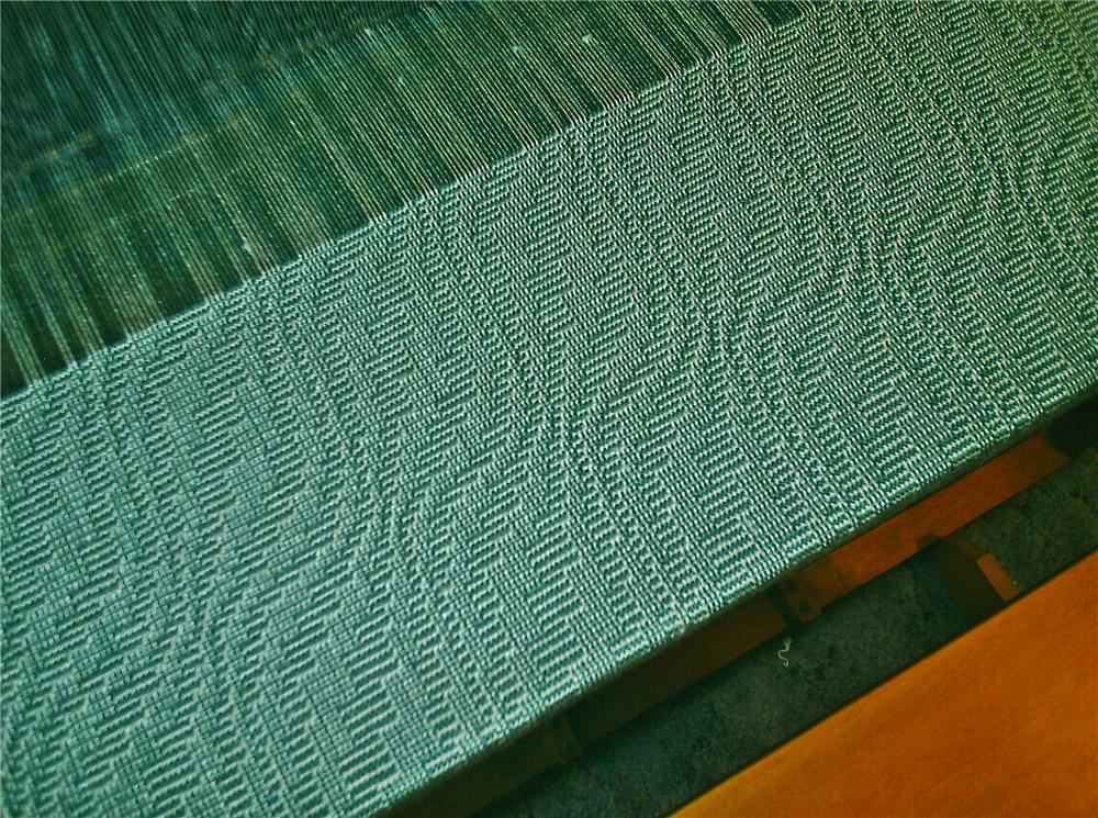 Green cloth on loom